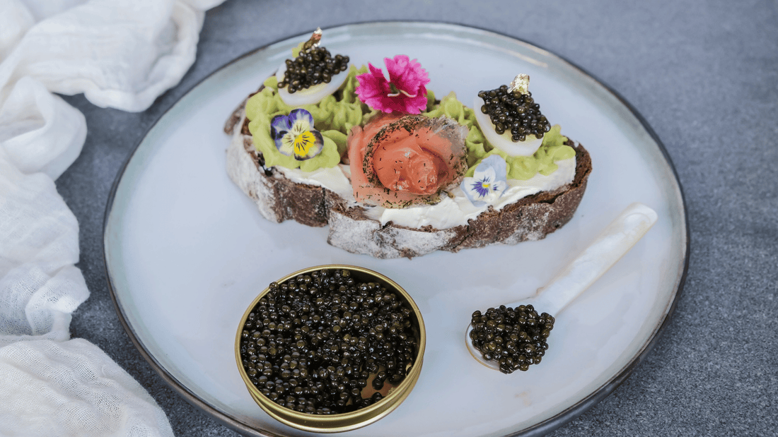 Soft-boiled egg cut open in an eggcup, topped with dark caviar, morning light