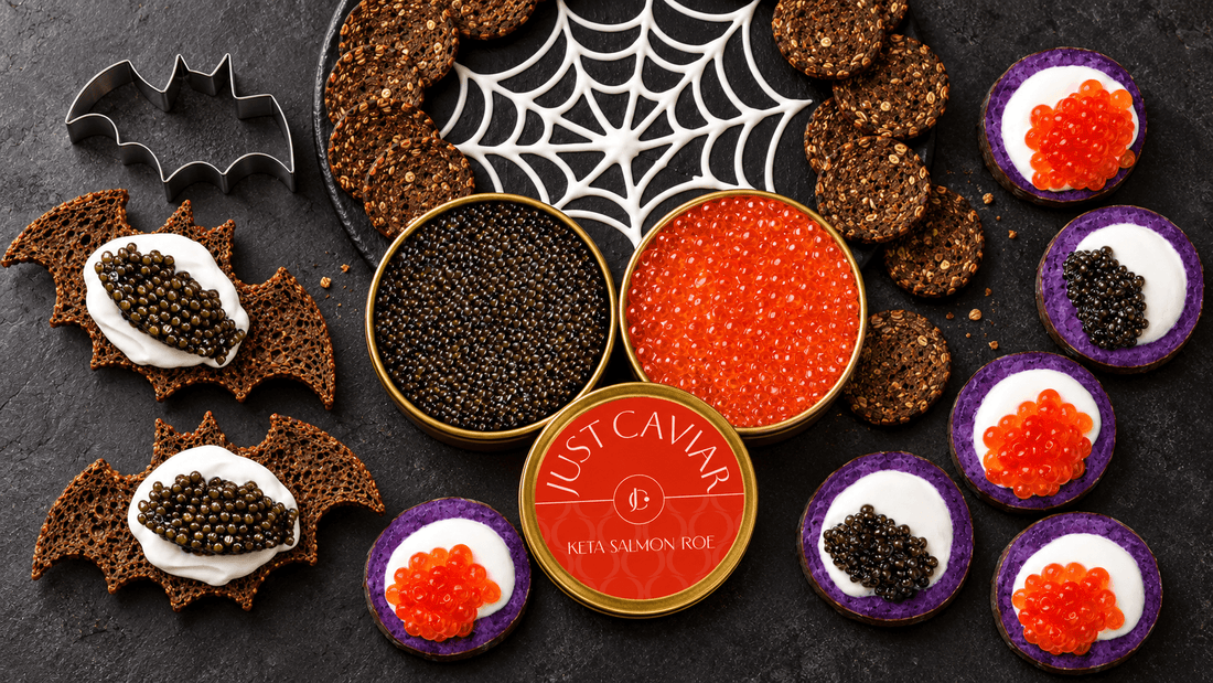 Halloween appetizers with sturgeon caviar and Keta salmon roe on a dark table